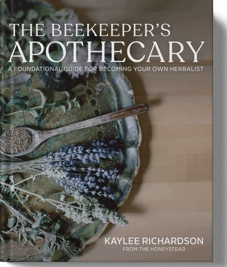 Book cover of 'The Beekeeper's Apothecary' with herbs and a spoon on a wooden surface.